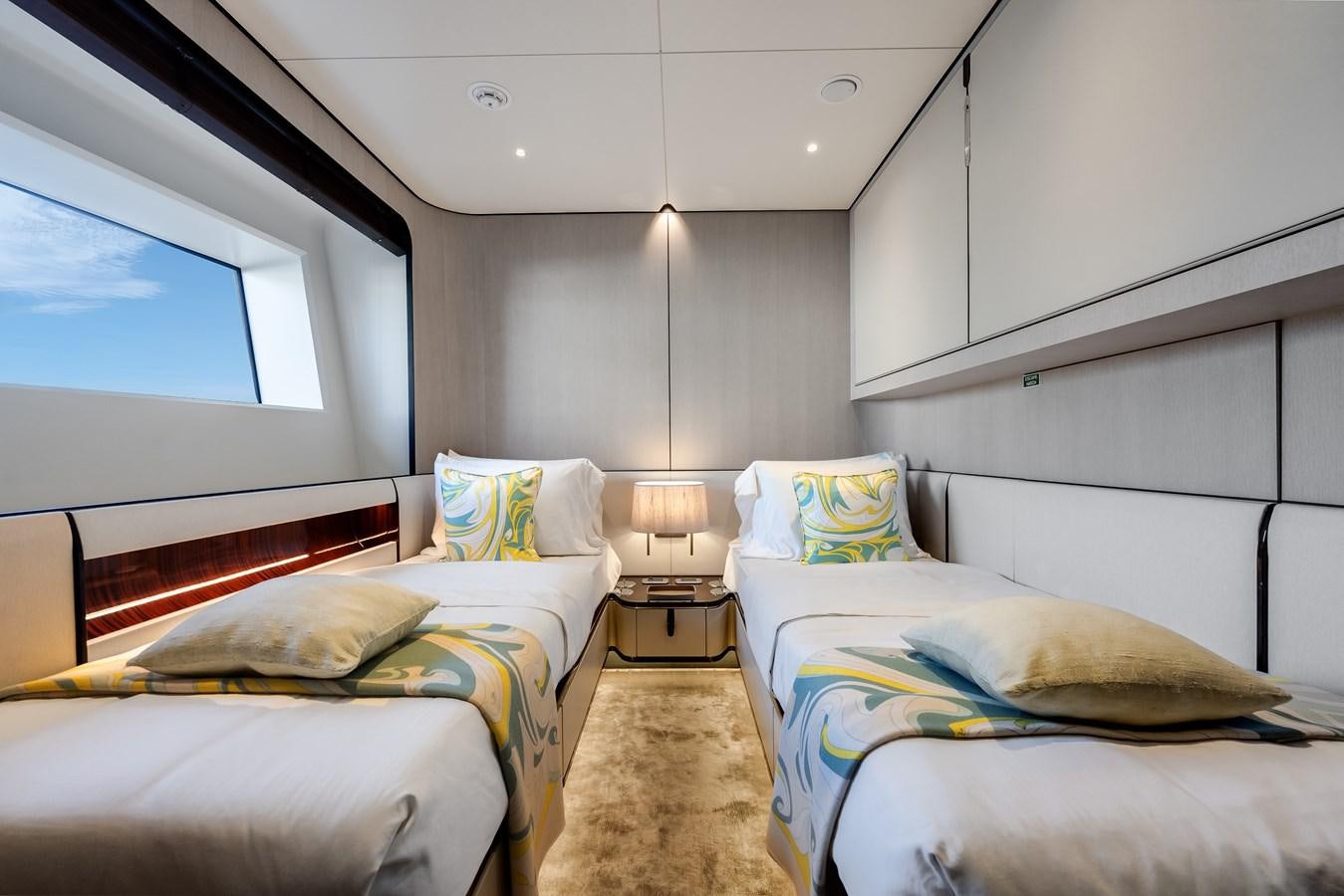 a room with two beds aboard AMICO Yacht for Sale