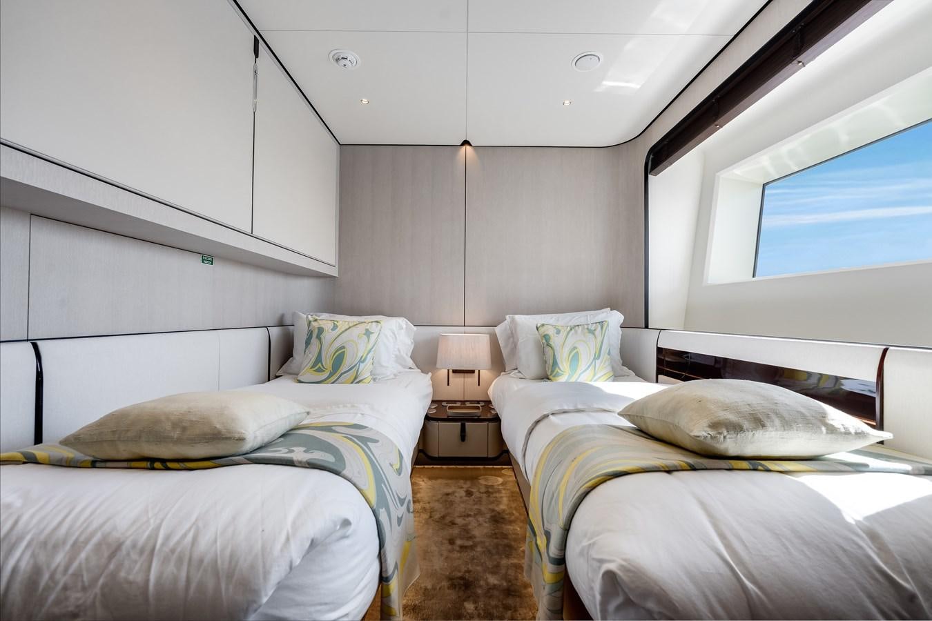 a room with two beds aboard AMICO Yacht for Sale
