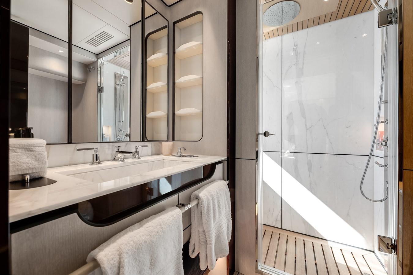 a bathroom with a sink and a mirror aboard AMICO Yacht for Sale