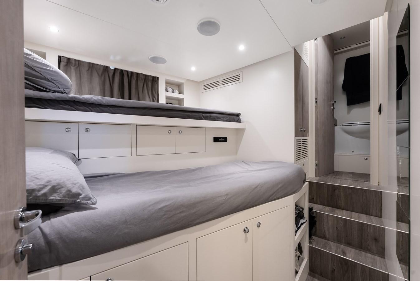 a room with a bed and a closet aboard AMICO Yacht for Sale