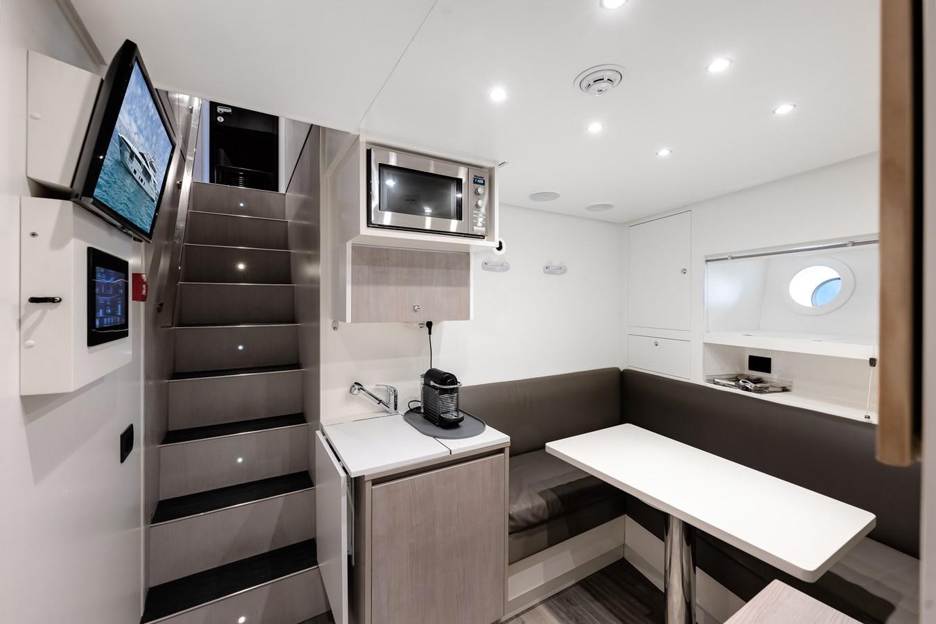a room with a desk and a tv aboard AMICO Yacht for Sale
