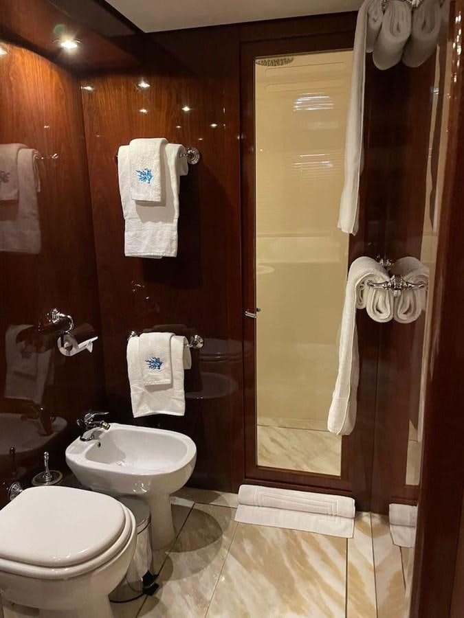 a bathroom with a toilet and sink aboard SKYLINE Yacht for Sale