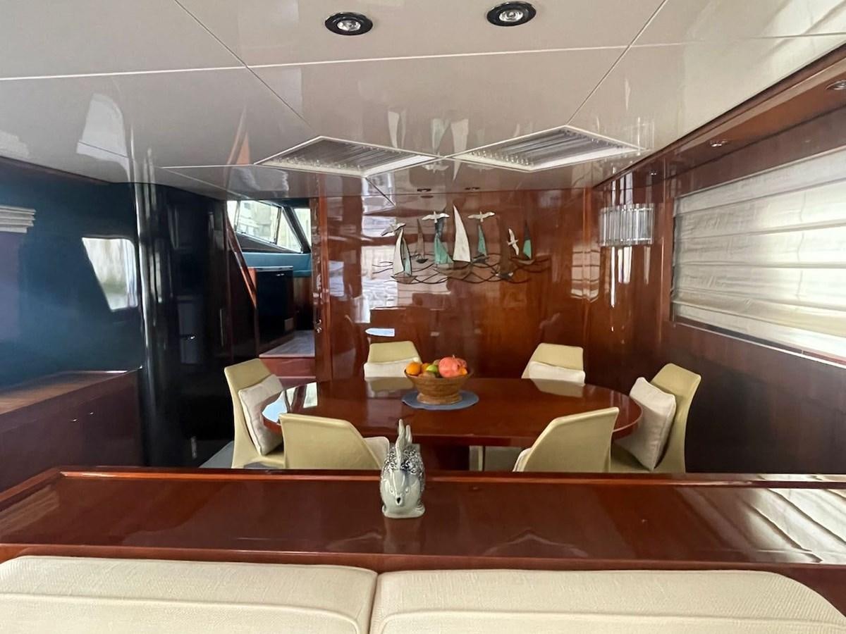 a room with a table and chairs aboard SKYLINE Yacht for Sale