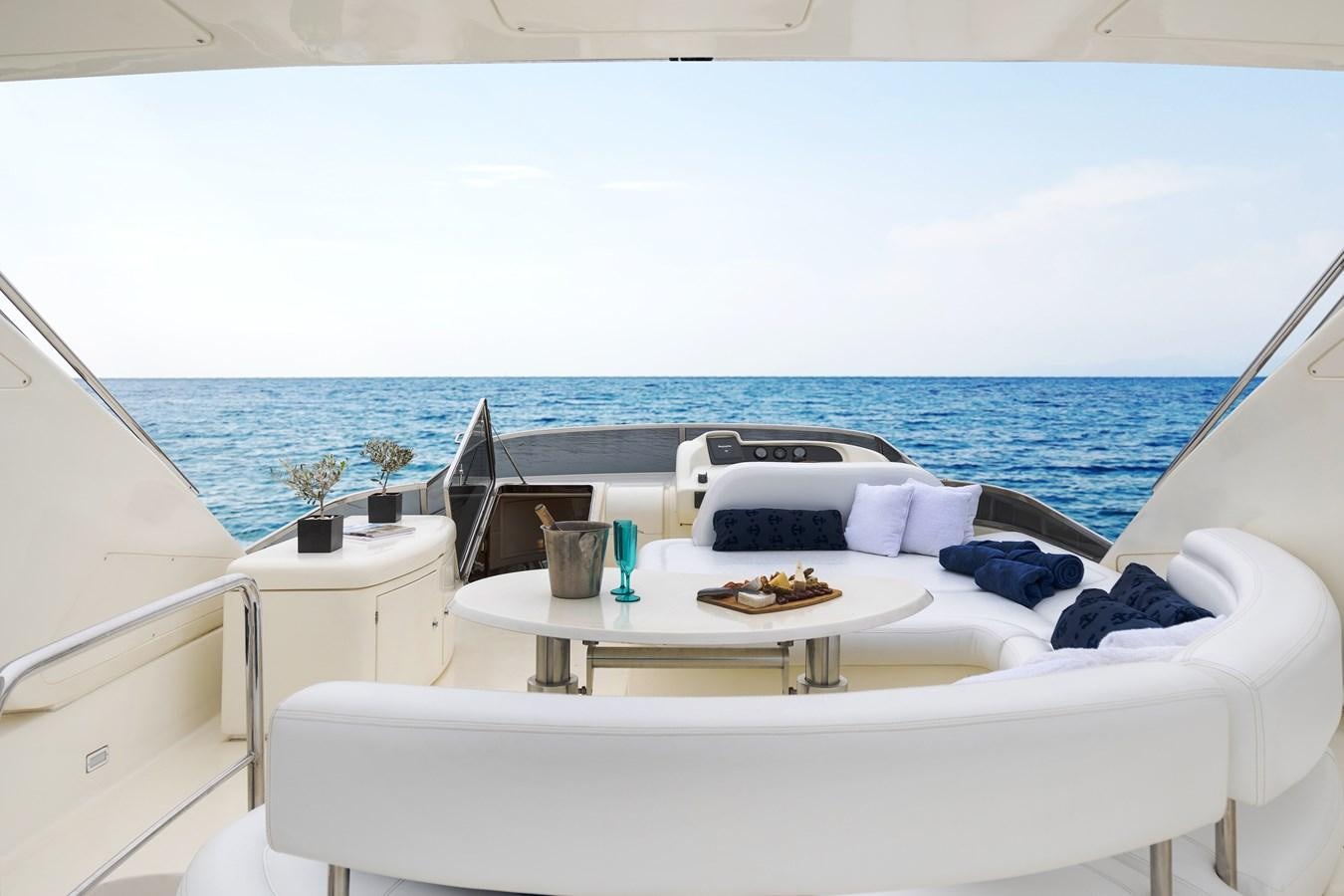 a room with a bed and a table with food on it aboard ESTIA ZEUS Yacht for Sale