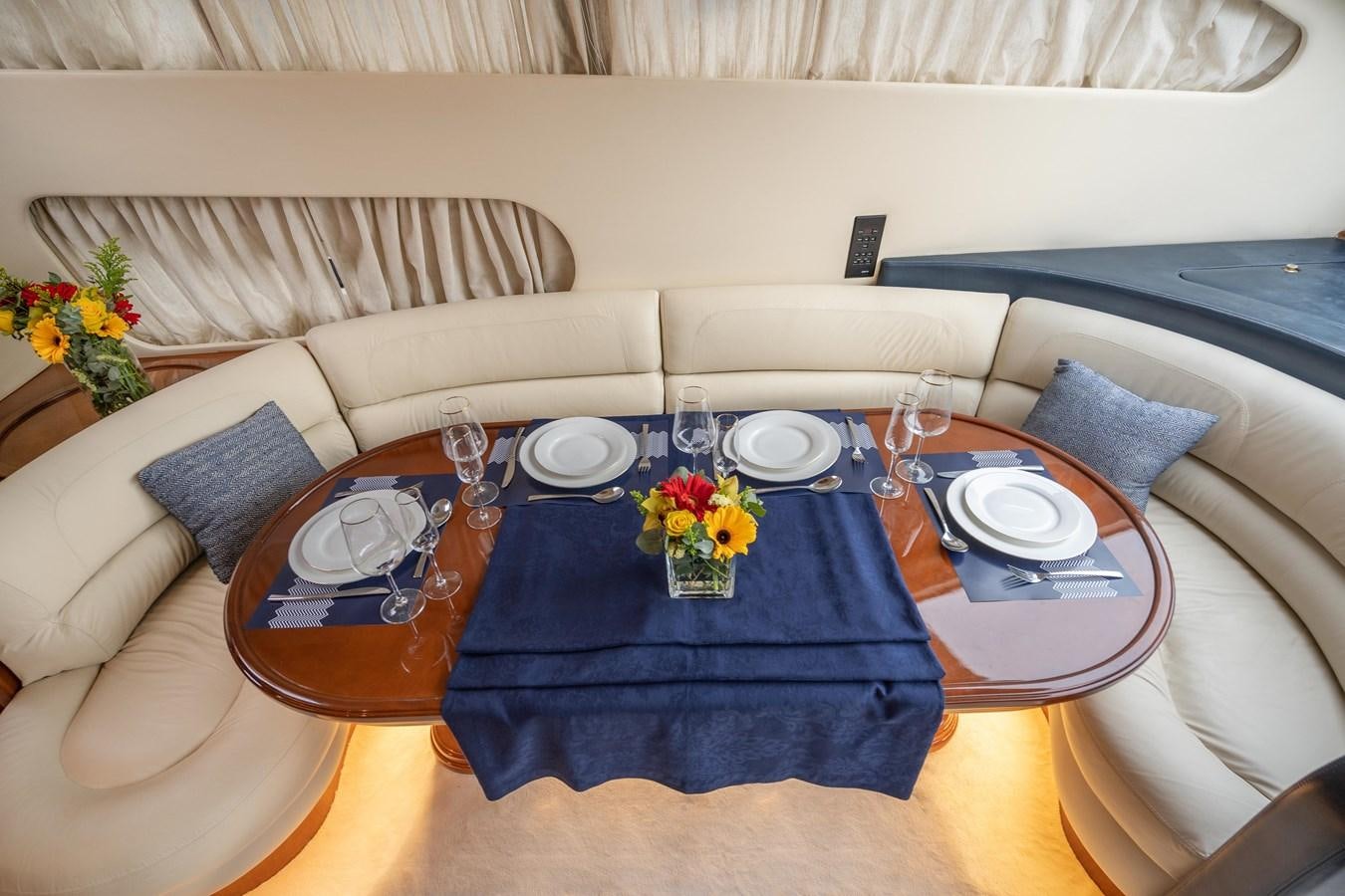 a table with plates and glasses on it aboard ESTIA ZEUS Yacht for Sale