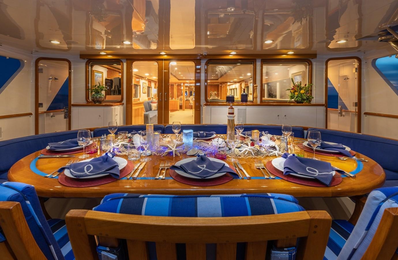 a table set with plates and glasses aboard RENA Yacht for Sale