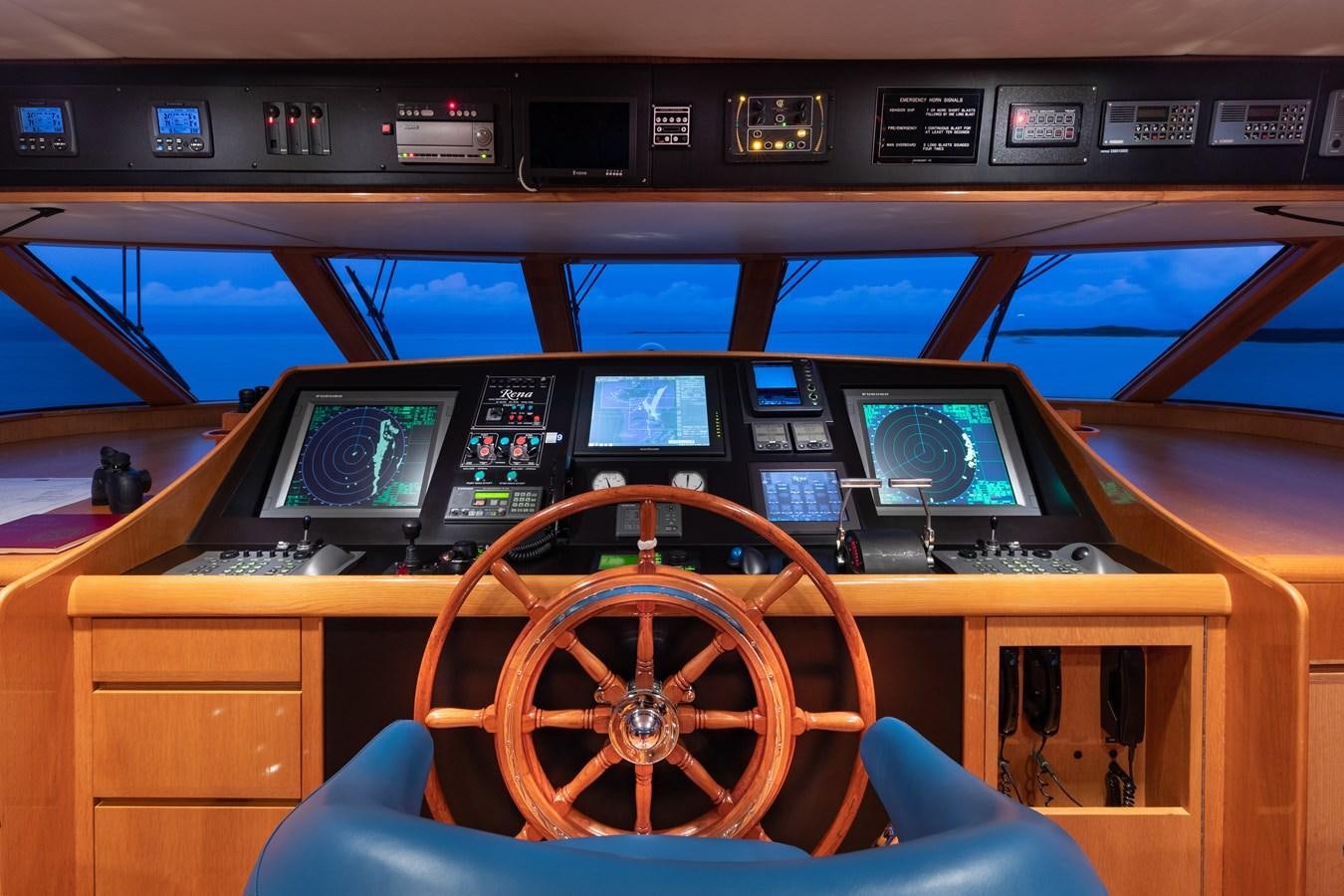 inside of a vehicle with a steering wheel and control panel aboard RENA Yacht for Sale