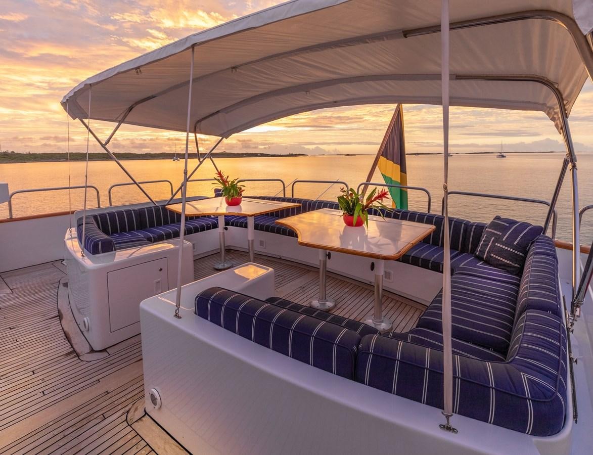 a boat with a table and chairs aboard RENA Yacht for Sale