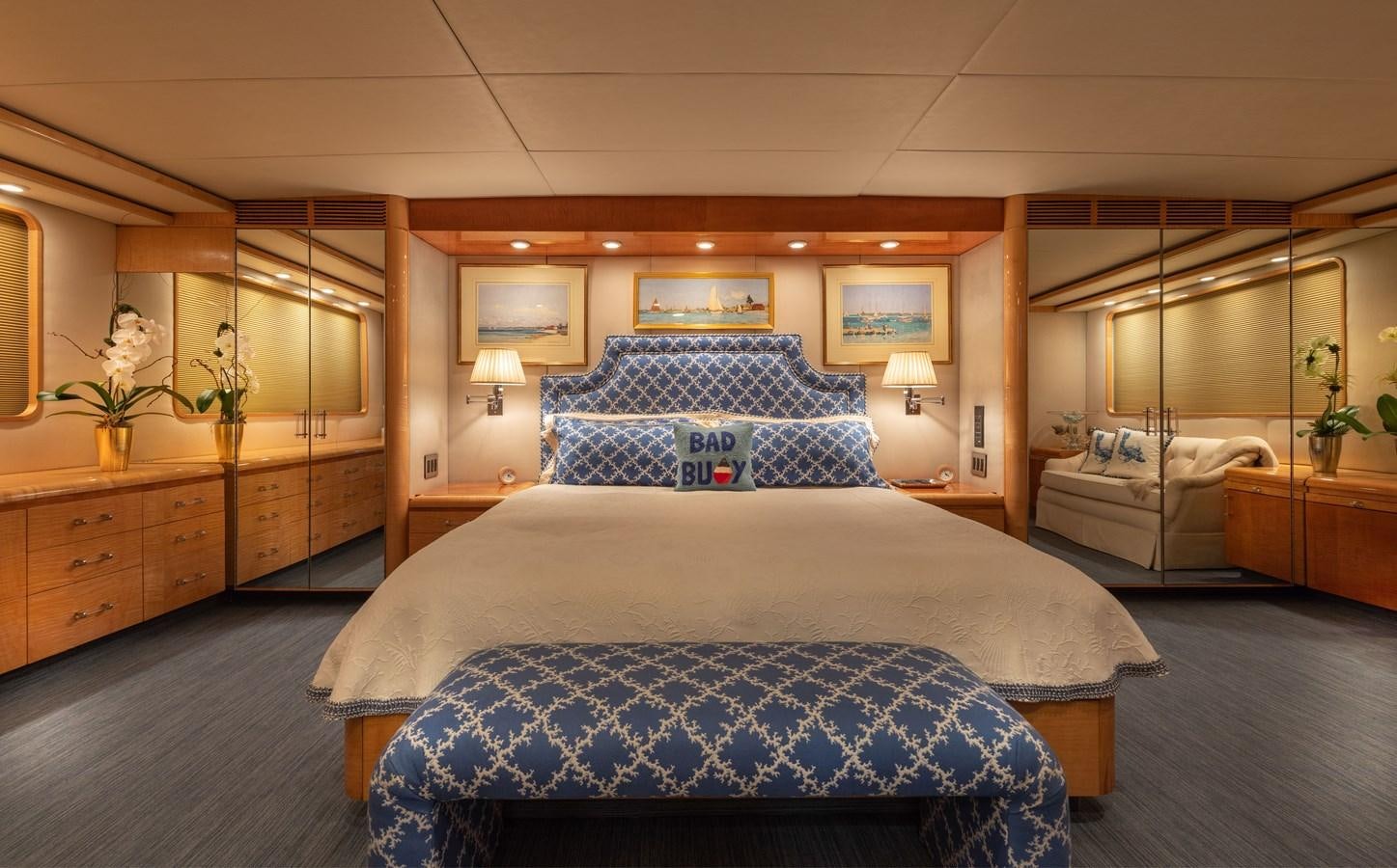 a bedroom with a bed and a mirror aboard RENA Yacht for Sale