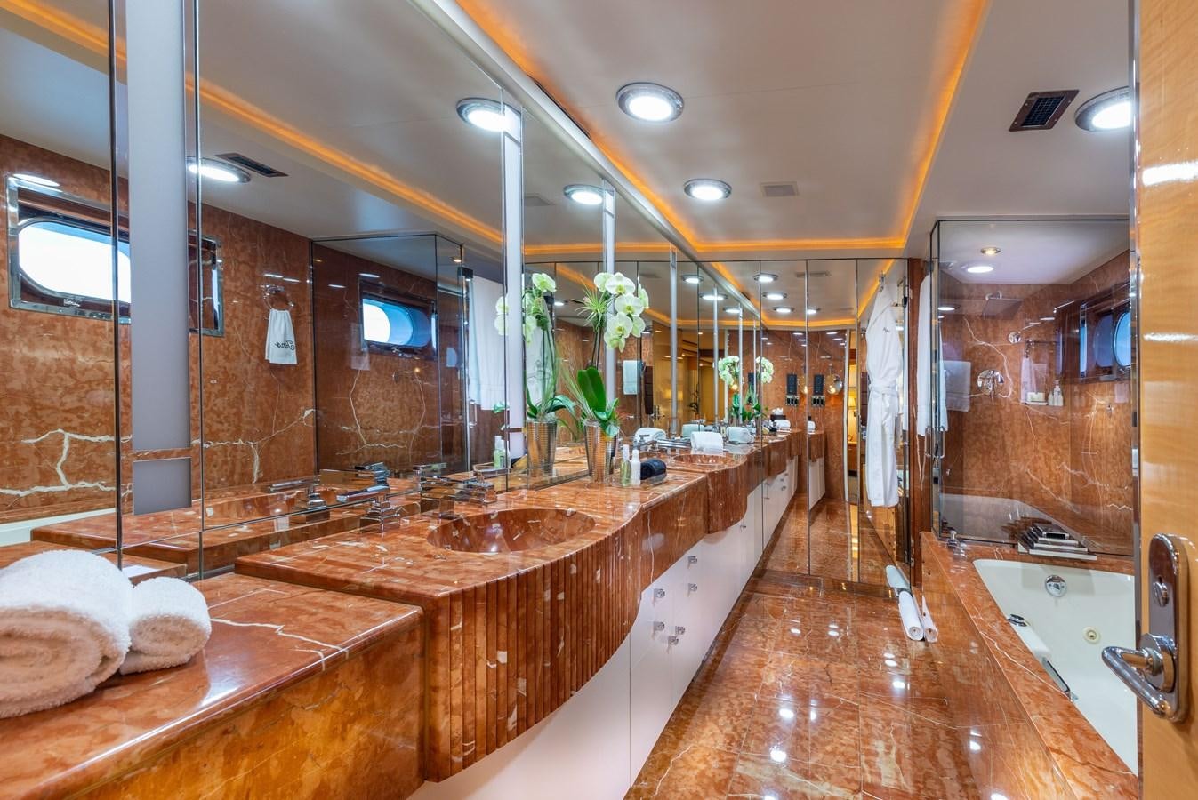 a bathroom with a countertop sink and a large mirror aboard RENA Yacht for Sale