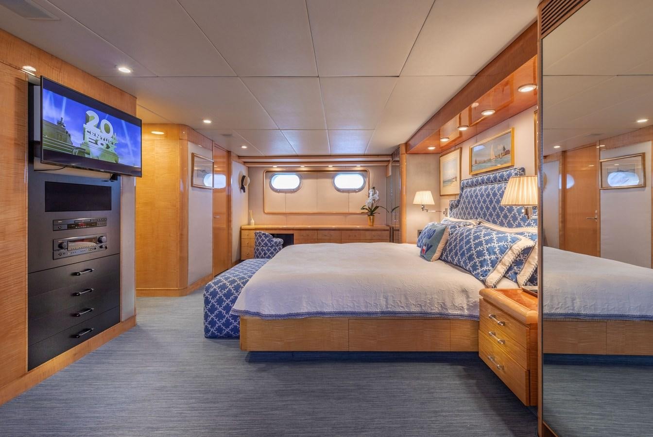 a hotel room with a tv and bed aboard RENA Yacht for Sale