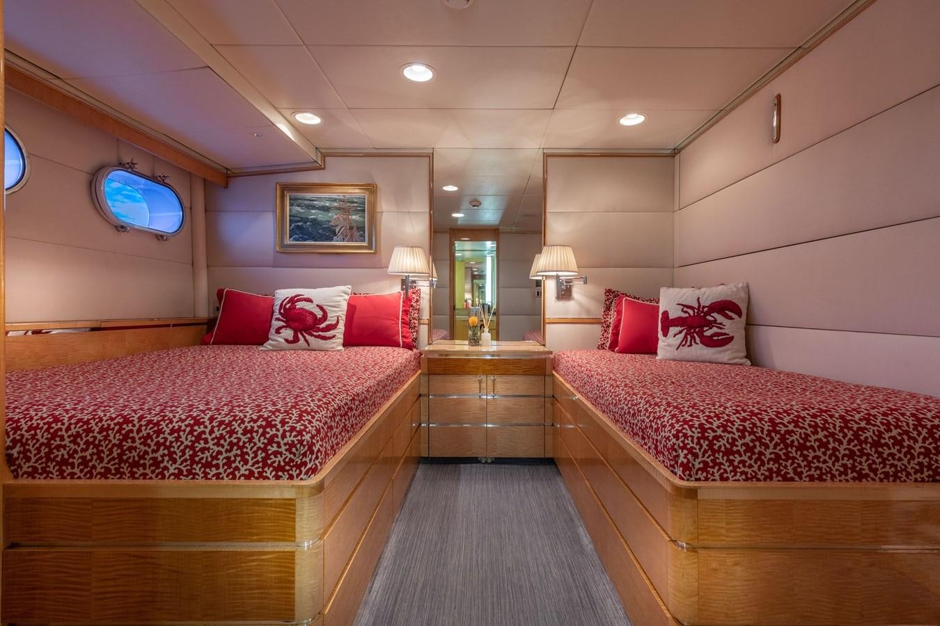 a room with beds and a mirror aboard RENA Yacht for Sale