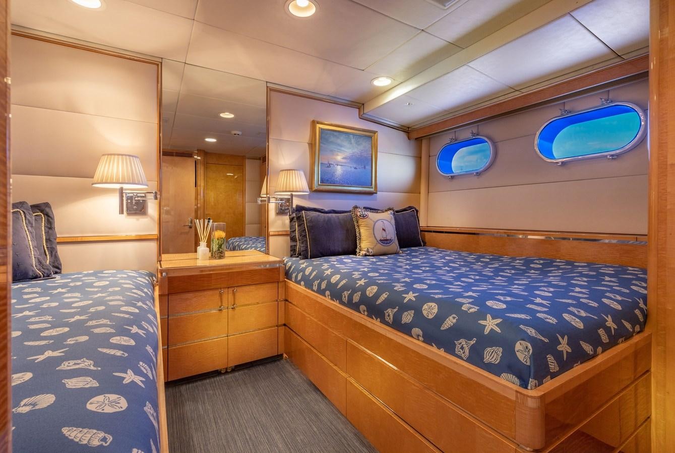 a bedroom with a bed and a desk aboard RENA Yacht for Sale