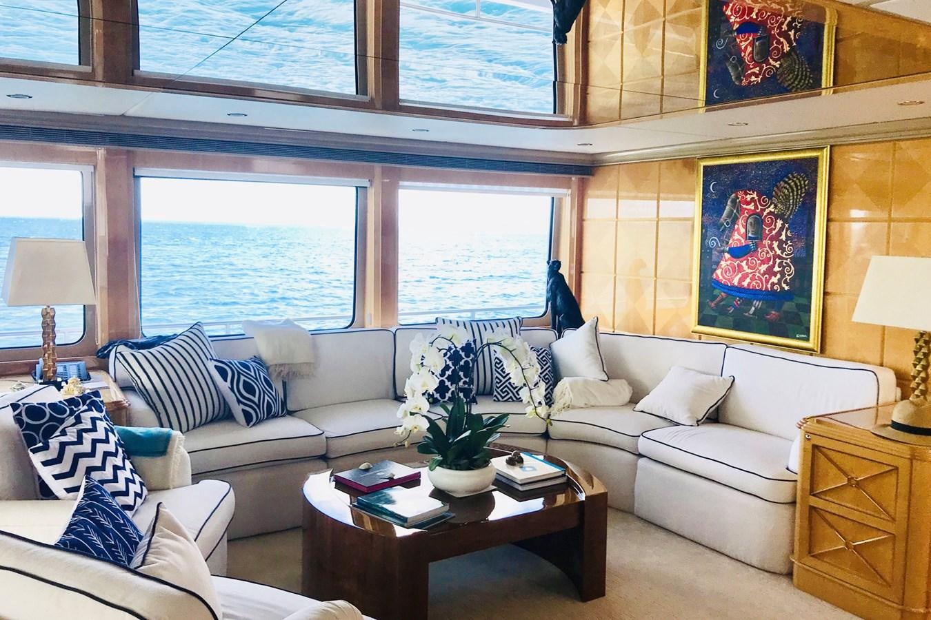 a living room with a couch and a table aboard LADY AZUL Yacht for Sale