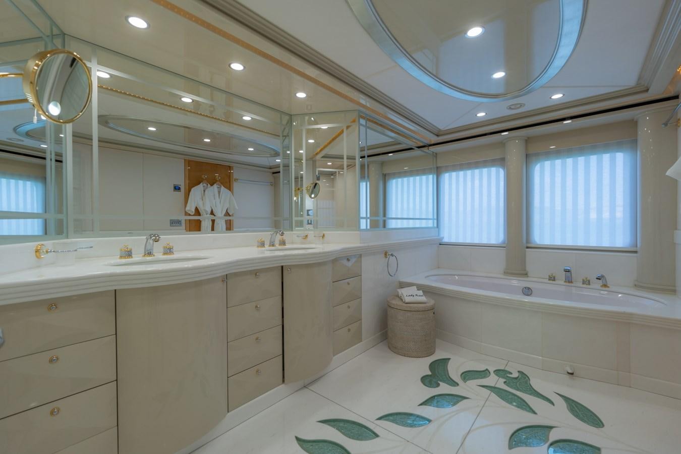 a bathroom with a tub sink and a large mirror aboard LADY AZUL Yacht for Sale