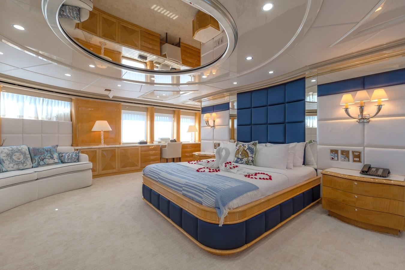 a large room with a bed and a desk aboard LADY AZUL Yacht for Sale