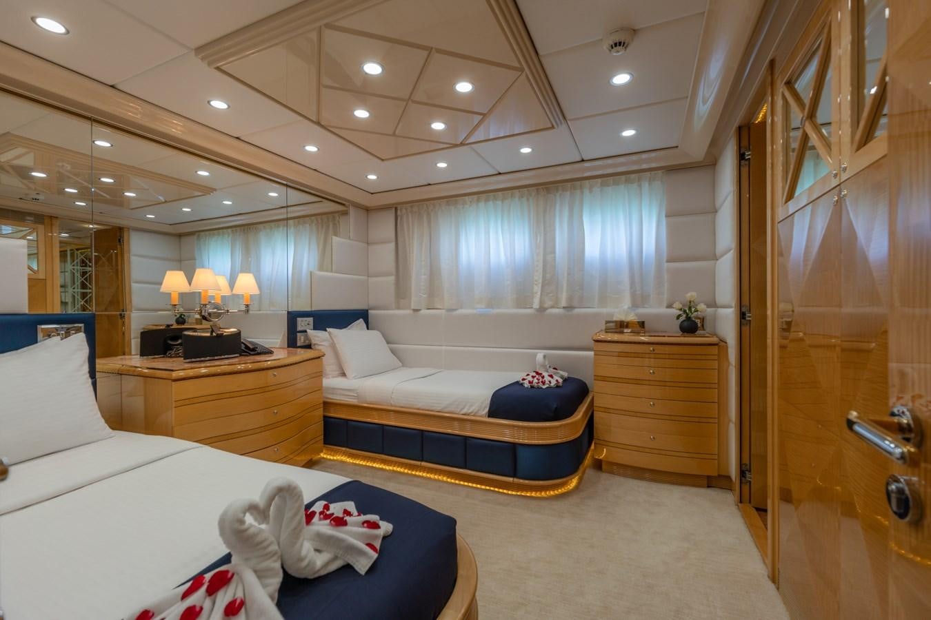 a bedroom with a bed and a closet aboard LADY AZUL Yacht for Sale