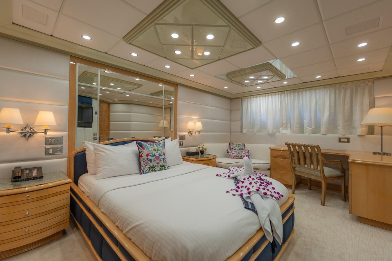a bedroom with a bed and a desk aboard LADY AZUL Yacht for Sale