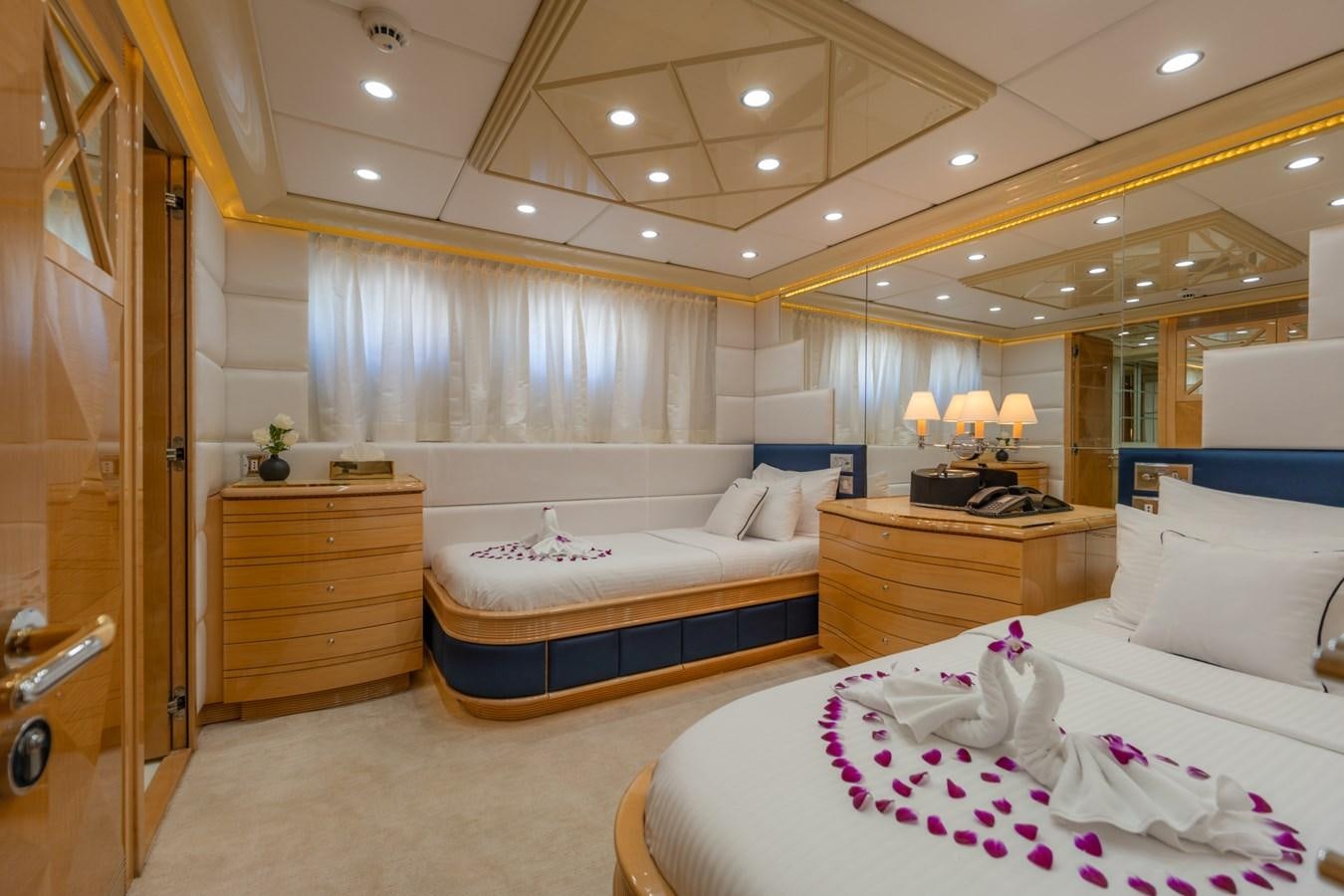 a bedroom with a bed and a mirror aboard LADY AZUL Yacht for Sale