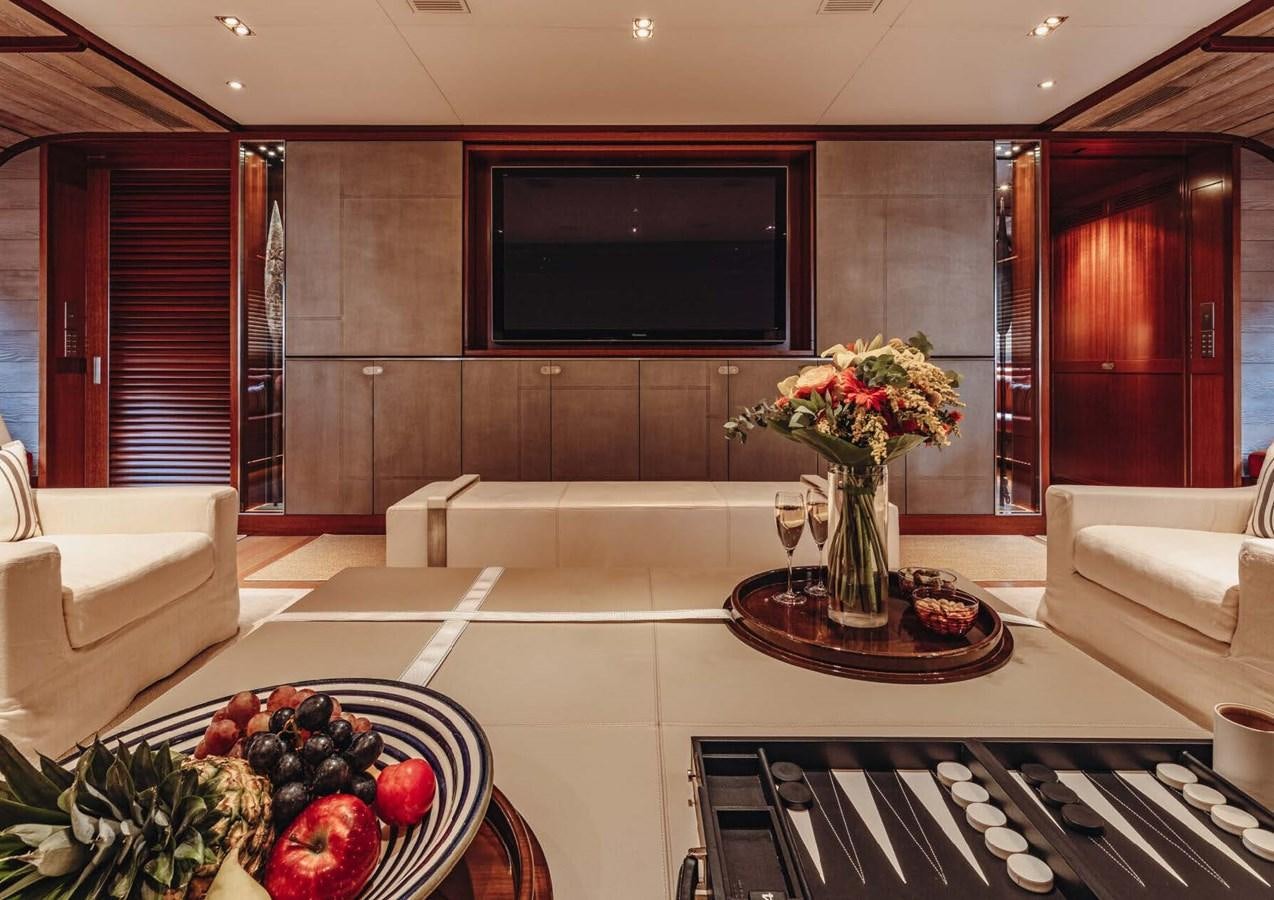 a living room with a table and couches aboard ROSEHEARTY Yacht for Sale