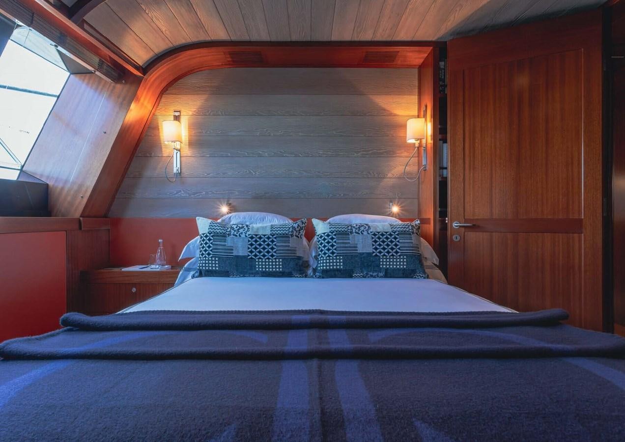 a bed with a blue comforter aboard ROSEHEARTY Yacht for Sale