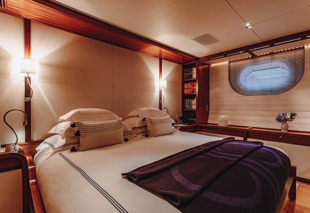 a room with a bed and a book shelf aboard ROSEHEARTY Yacht for Sale