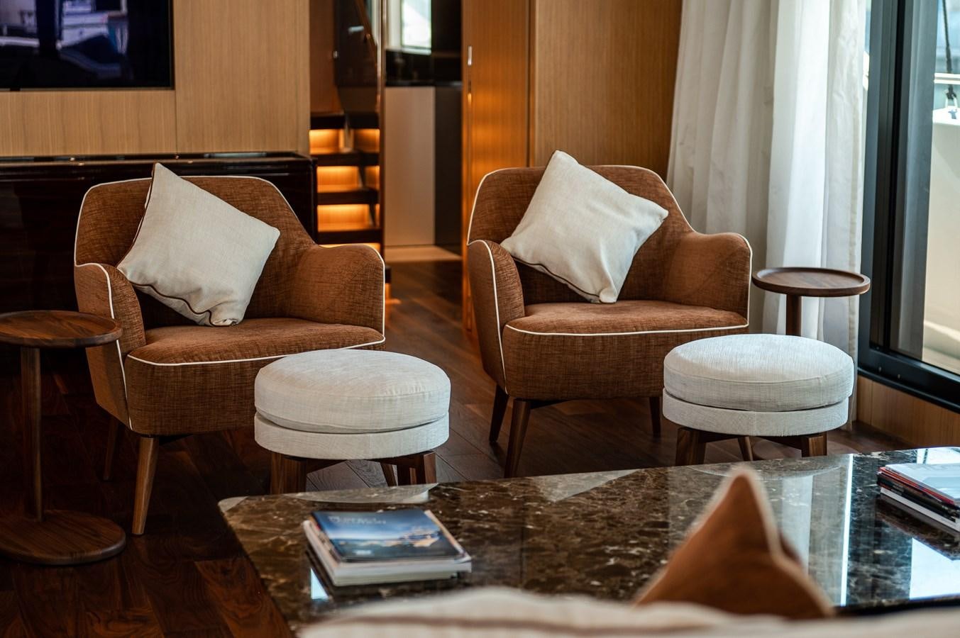 a living room with a table and chairs aboard VISSOTTA Yacht for Sale