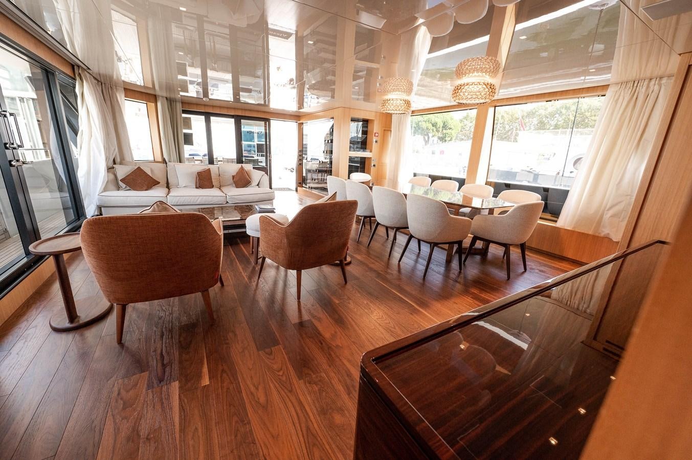 a room with tables and chairs aboard VISSOTTA Yacht for Sale