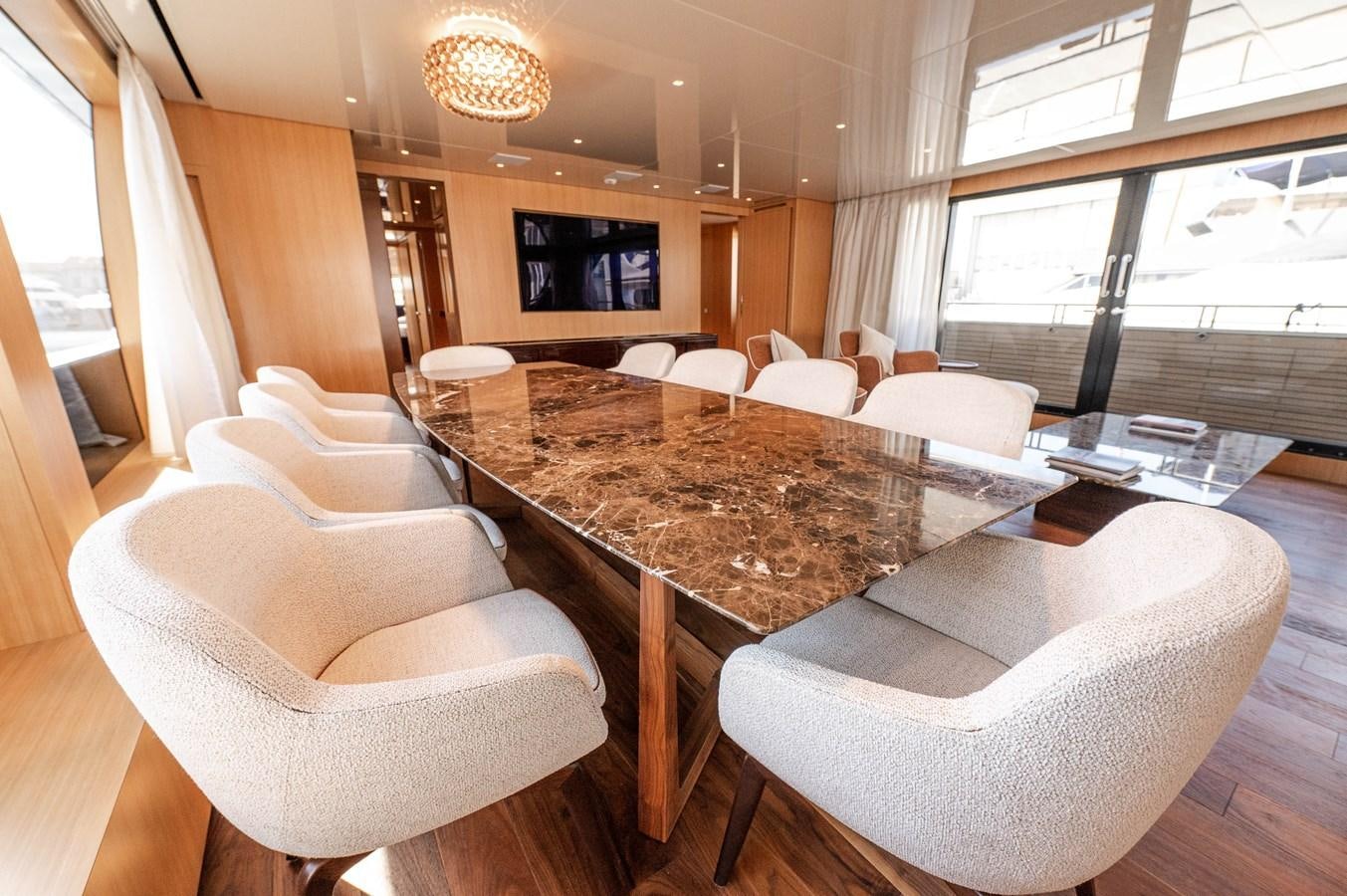 a large living room with a large table and chairs aboard VISSOTTA Yacht for Sale