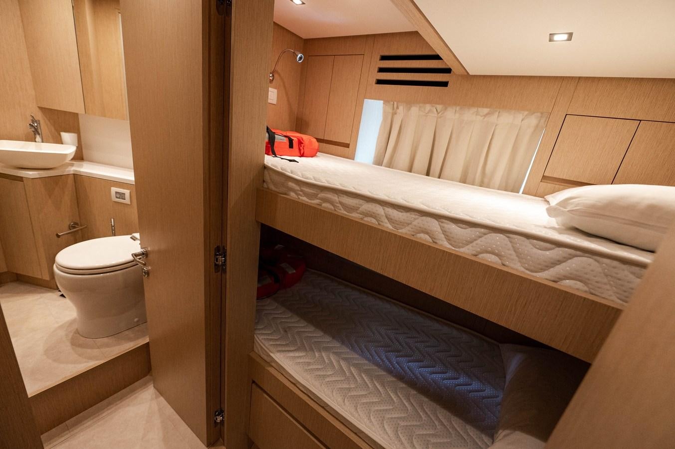 a bathroom with a bed and a sink aboard VISSOTTA Yacht for Sale