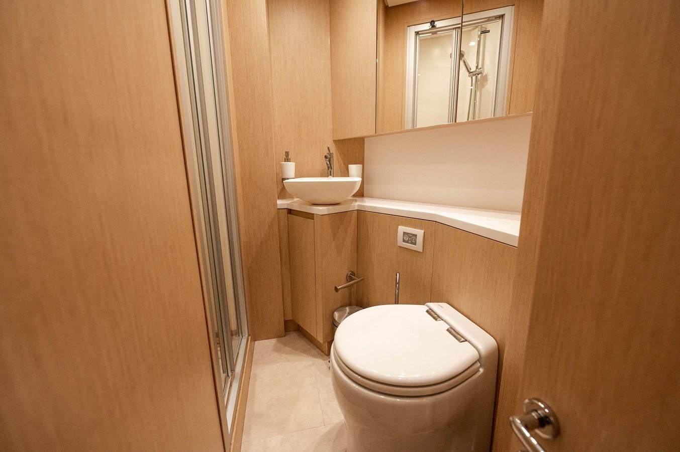 a bathroom with a toilet and sink aboard VISSOTTA Yacht for Sale