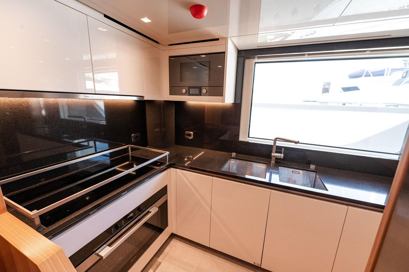 a kitchen with a large window aboard VISSOTTA Yacht for Sale