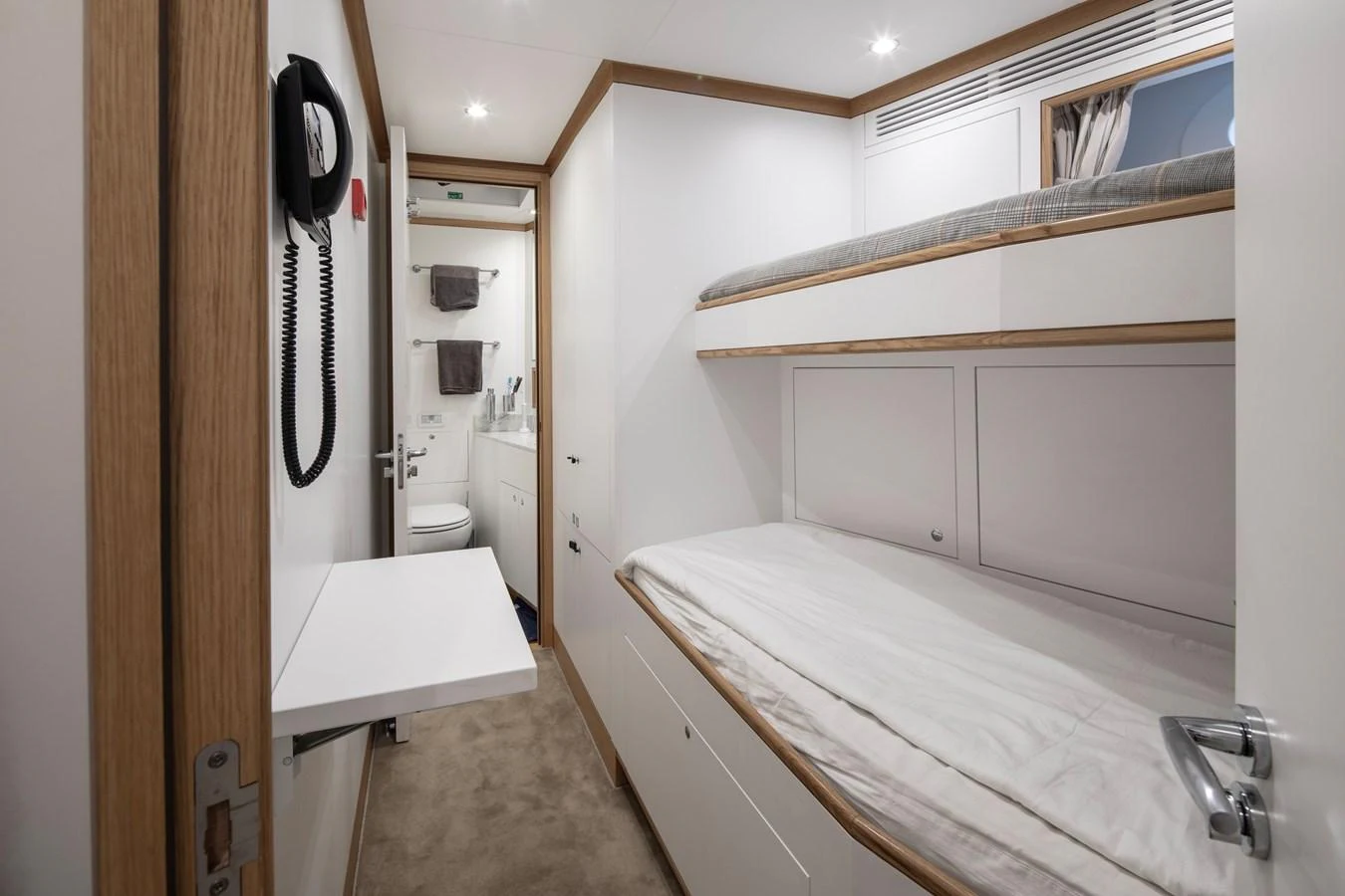 a small bedroom with a bed aboard LEXSEA Yacht for Sale