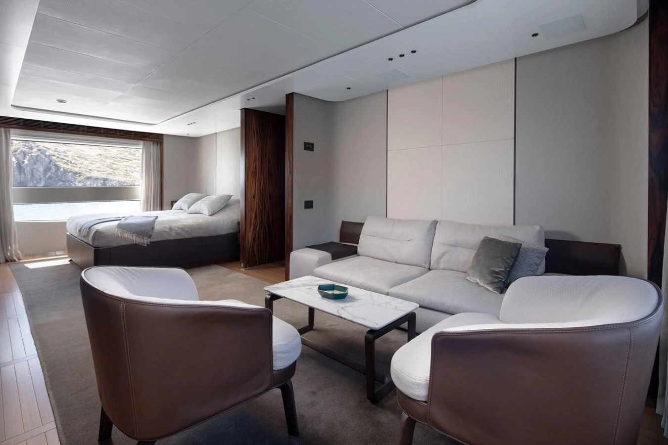 a living room with a couch and a table aboard LEXSEA Yacht for Sale