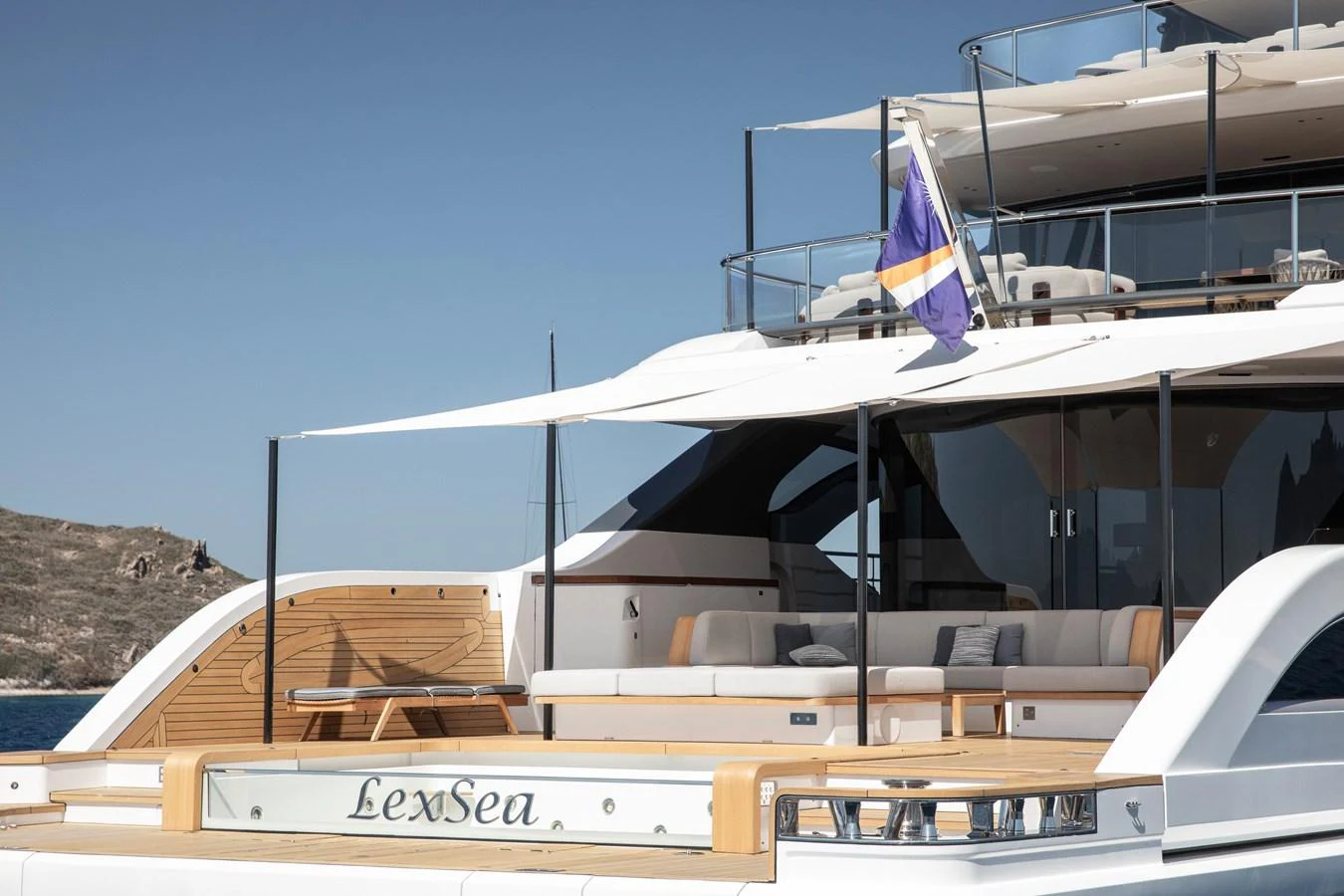a boat with a flag on the front aboard LEXSEA Yacht for Sale