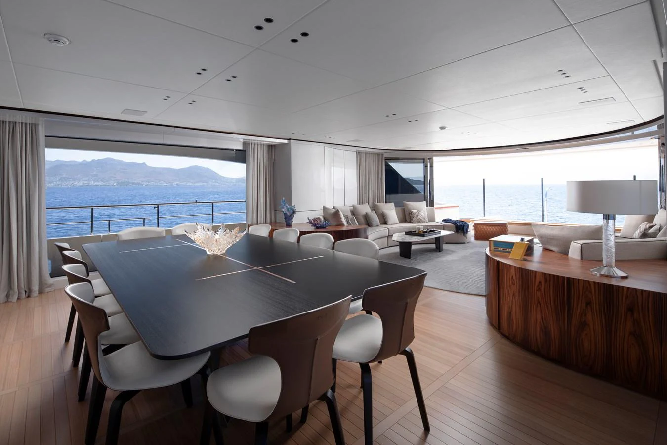a large room with a large table and chairs aboard LEXSEA Yacht for Sale