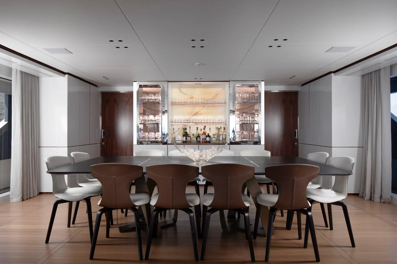 a large conference room with tables and chairs aboard LEXSEA Yacht for Sale