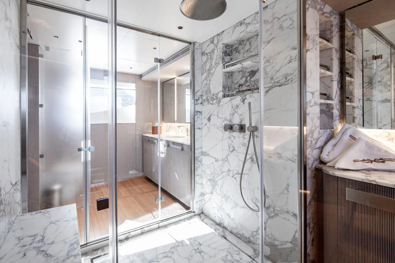 a bathroom with a glass shower aboard LEXSEA Yacht for Sale