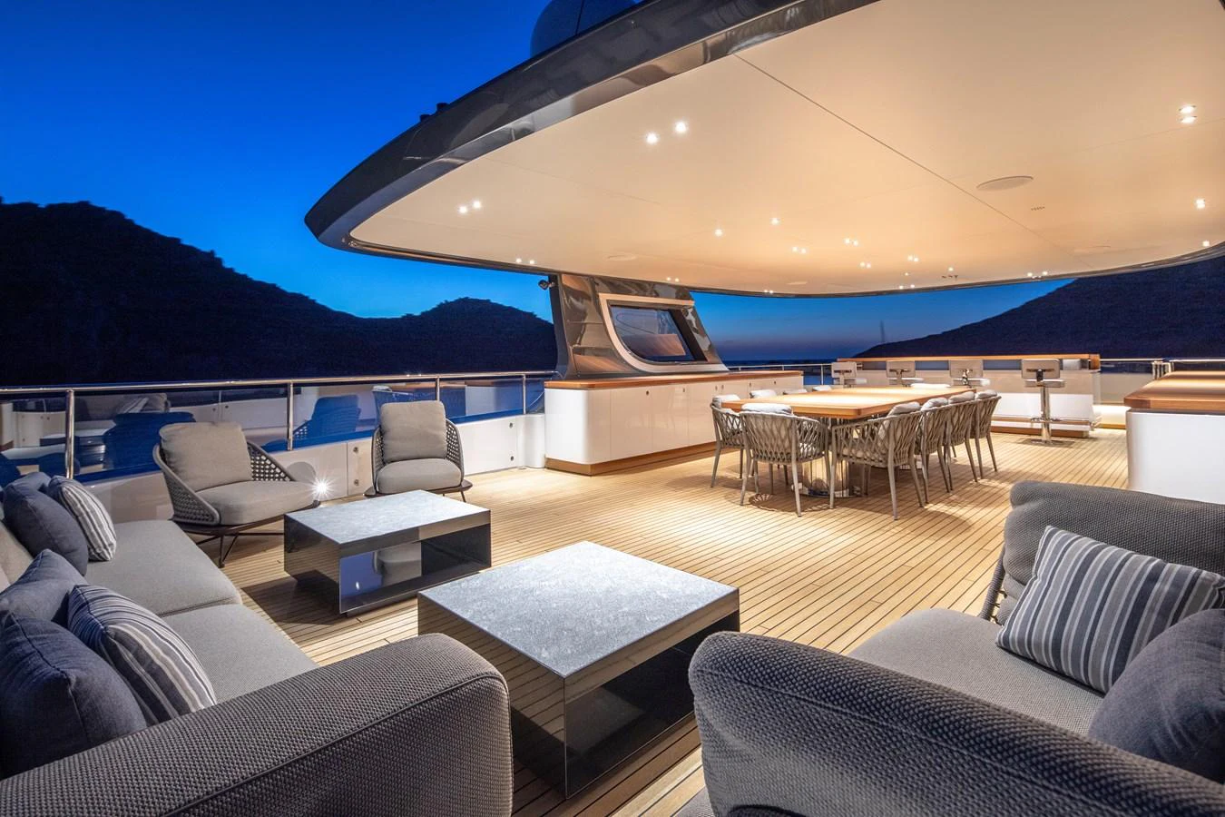 a living room with a large deck aboard LEXSEA Yacht for Sale