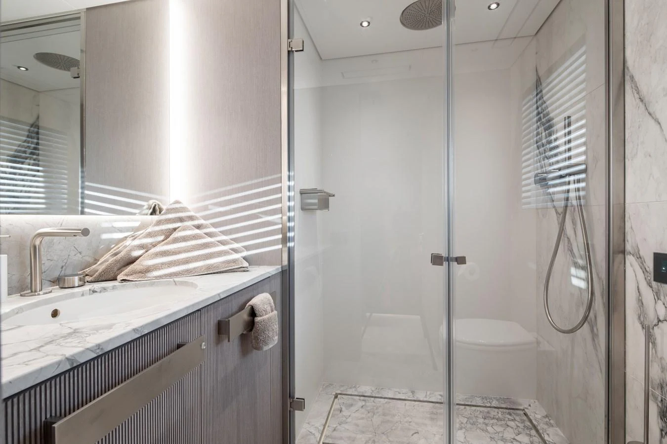 a bathroom with a glass shower aboard LEXSEA Yacht for Sale