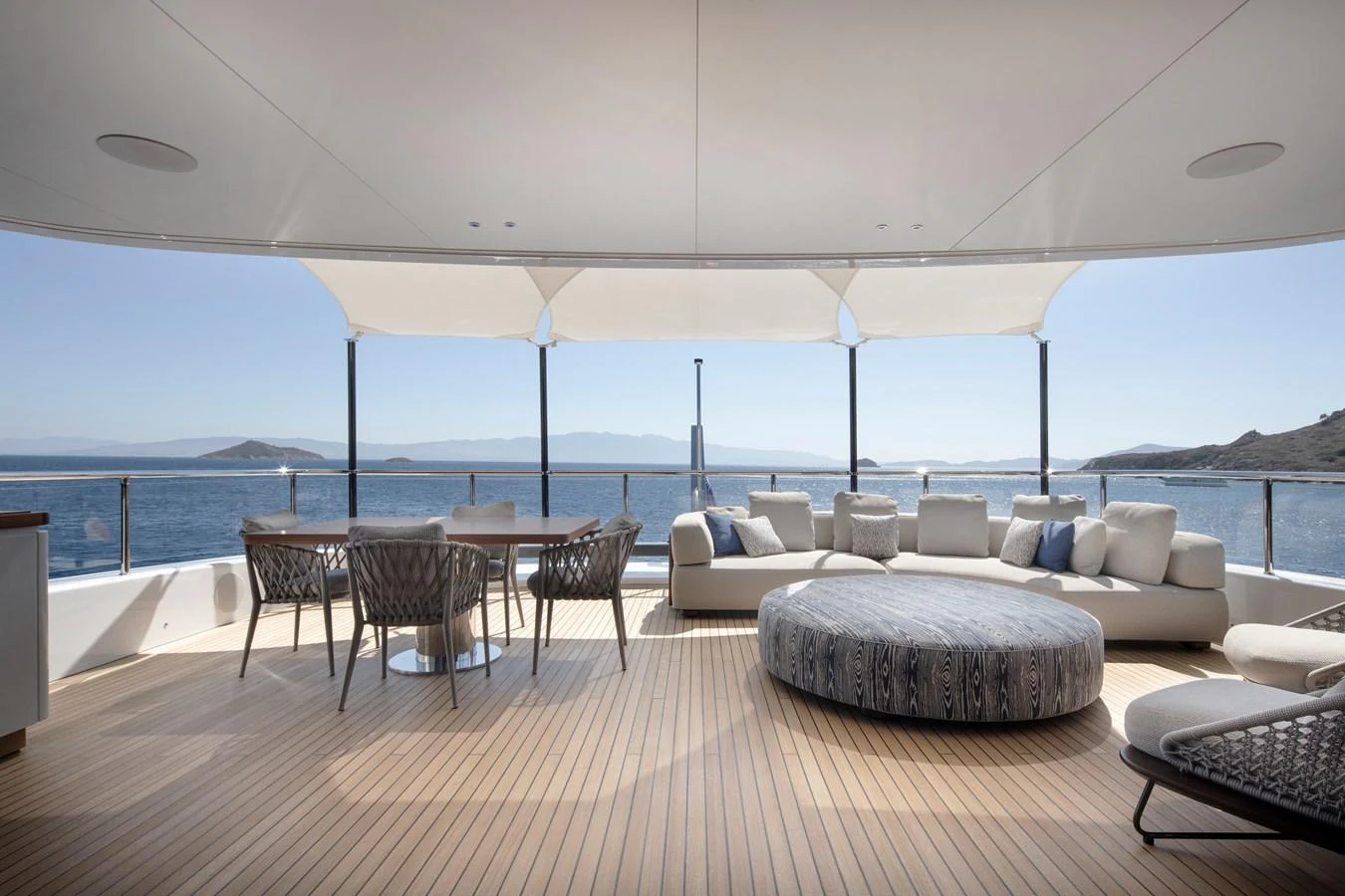 a large living room with a large balcony overlooking the ocean aboard LEXSEA Yacht for Sale