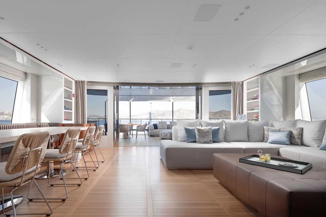 a living room with a wood floor aboard LEXSEA Yacht for Sale