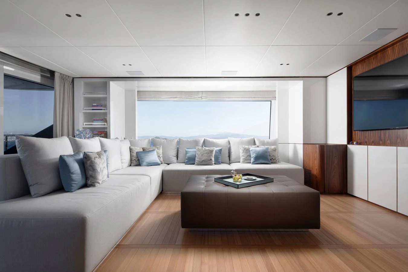 a living room with a couch and a table aboard LEXSEA Yacht for Sale