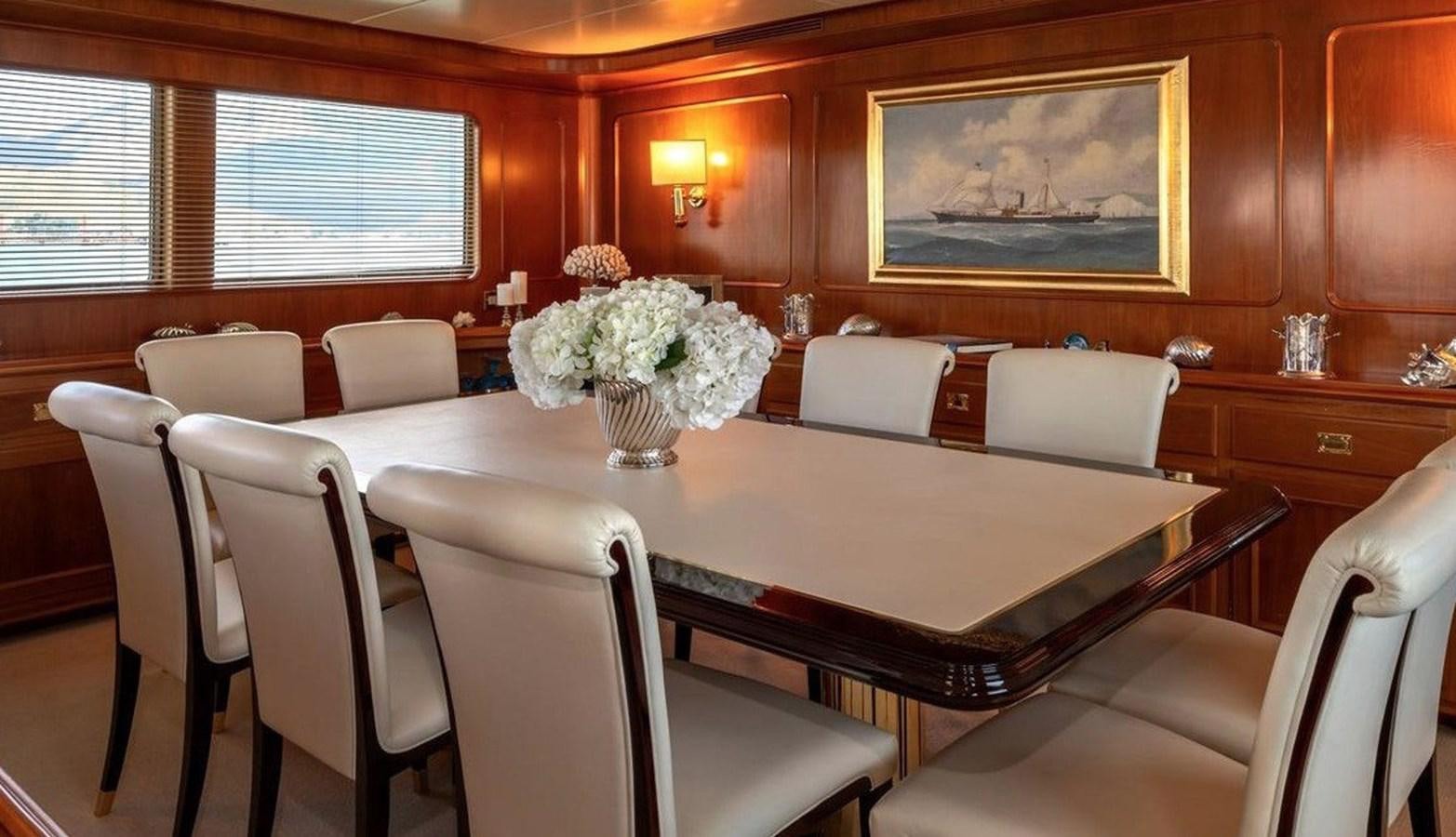 a dining room with white chairs aboard NIGHTFLOWER Yacht for Sale
