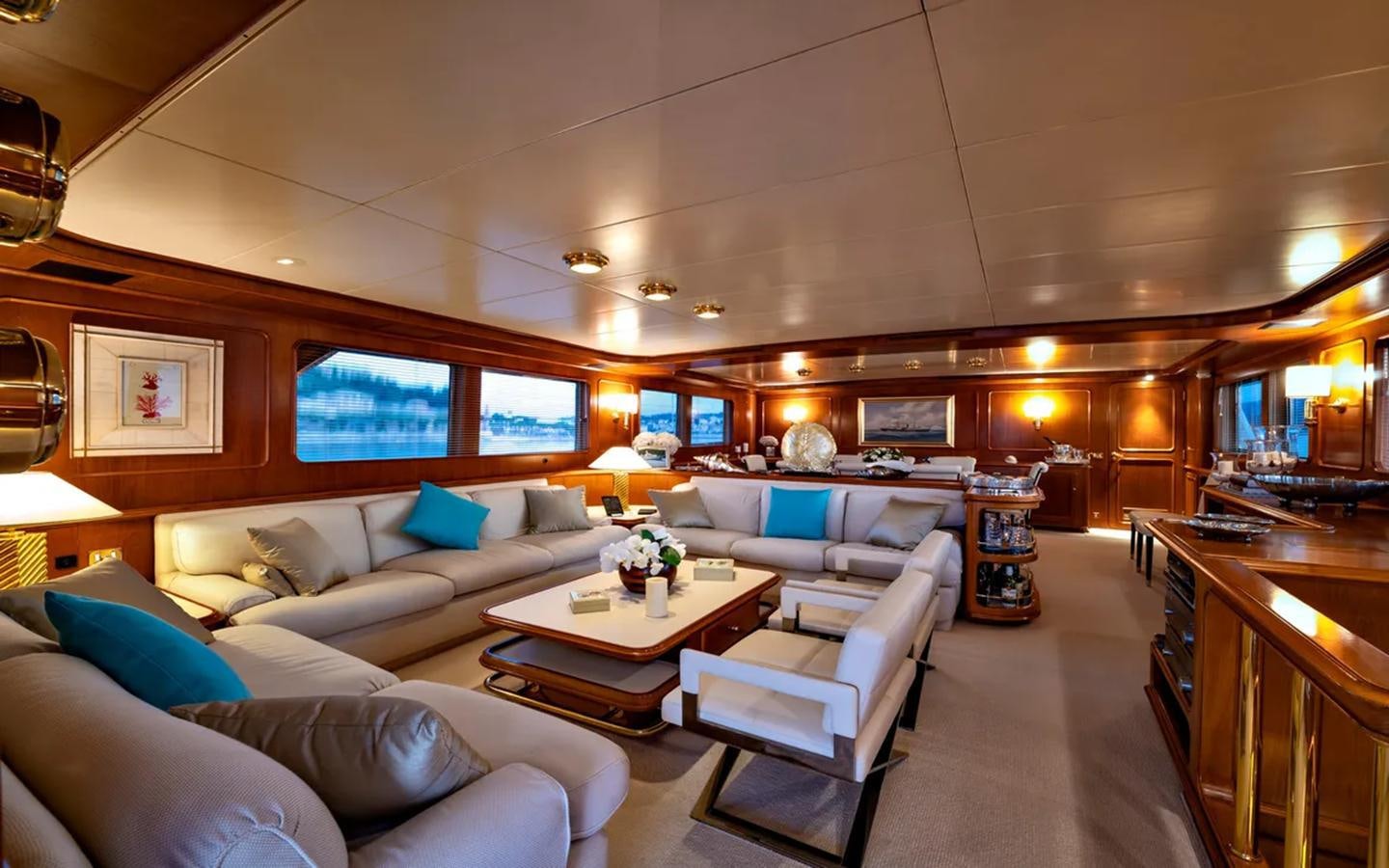 a room with a couch and a table and a window aboard NIGHTFLOWER Yacht for Sale