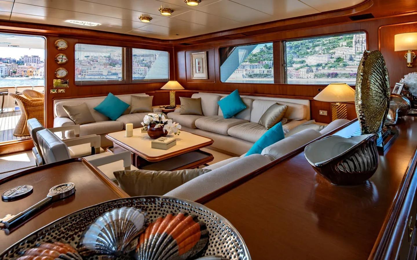 a living room with a large sofa and a coffee table aboard NIGHTFLOWER Yacht for Sale