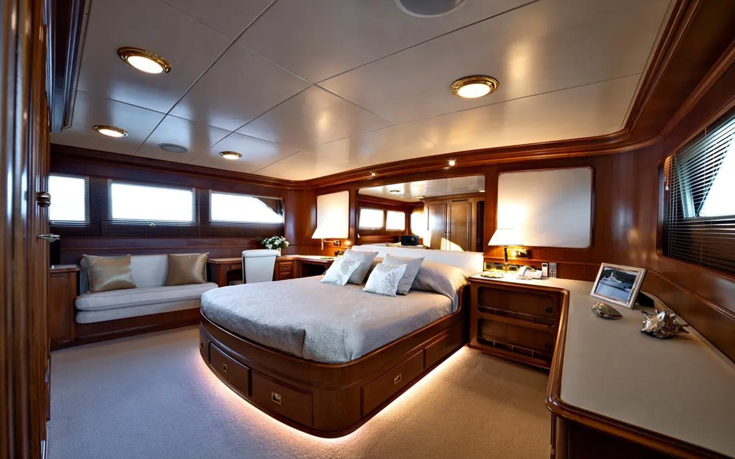 a room with a bed and a desk aboard NIGHTFLOWER Yacht for Sale