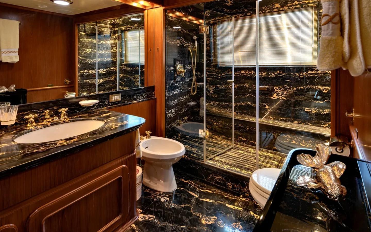 a bathroom with a sink toilet and a bathtub aboard NIGHTFLOWER Yacht for Sale