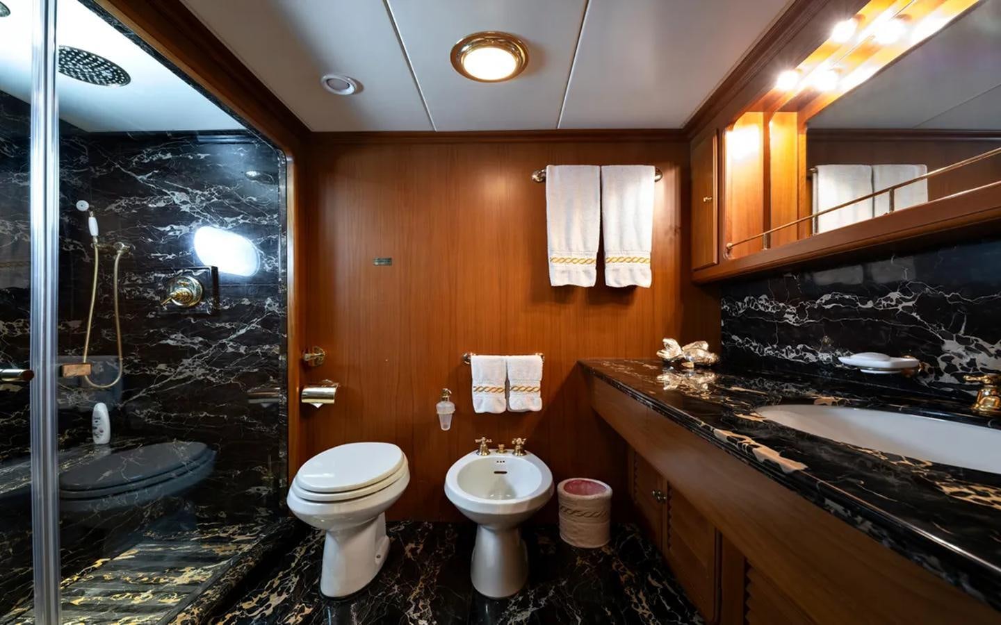 a bathroom with a tub sink and toilet aboard NIGHTFLOWER Yacht for Sale