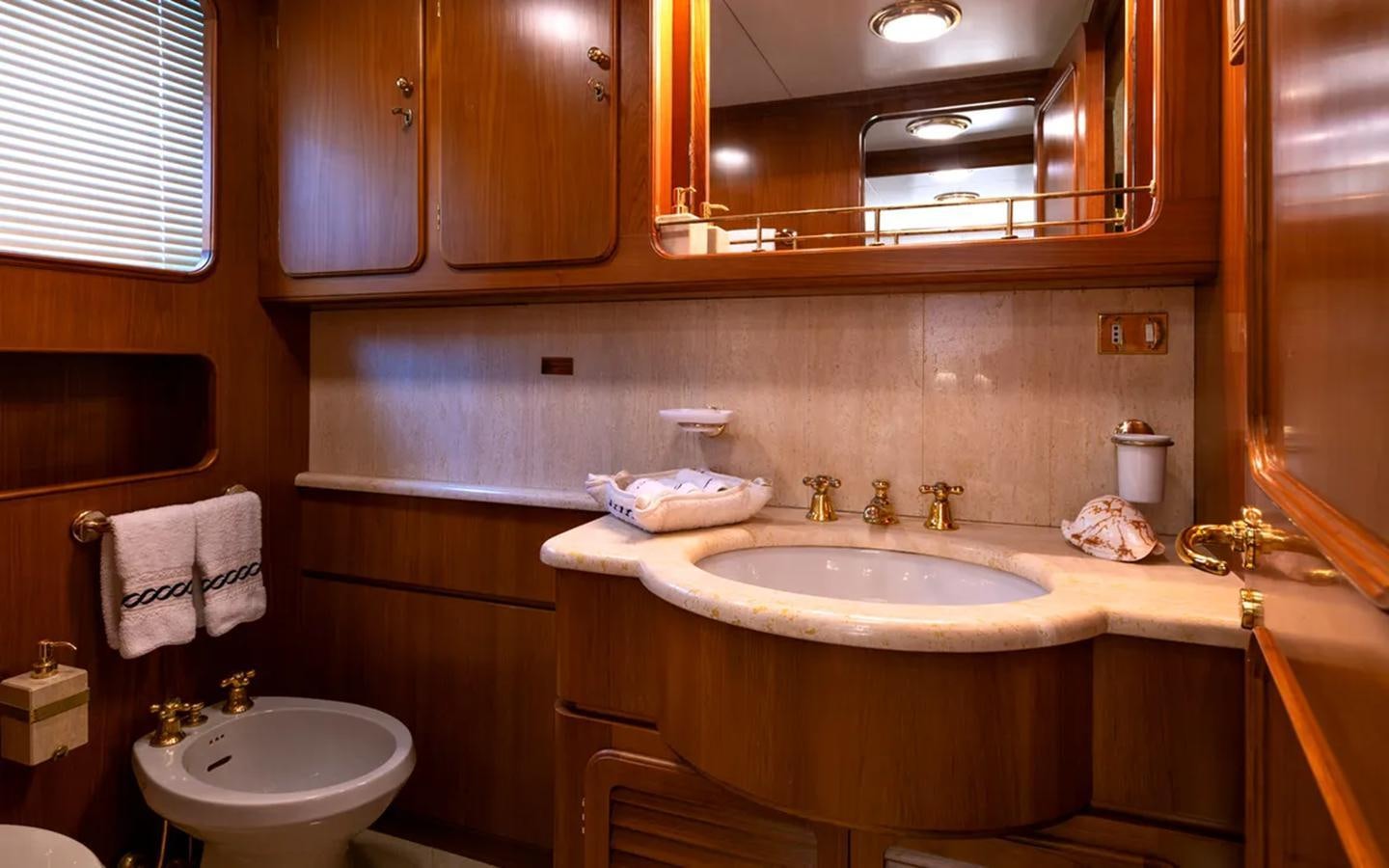 a bathroom with a sink and a mirror aboard NIGHTFLOWER Yacht for Sale
